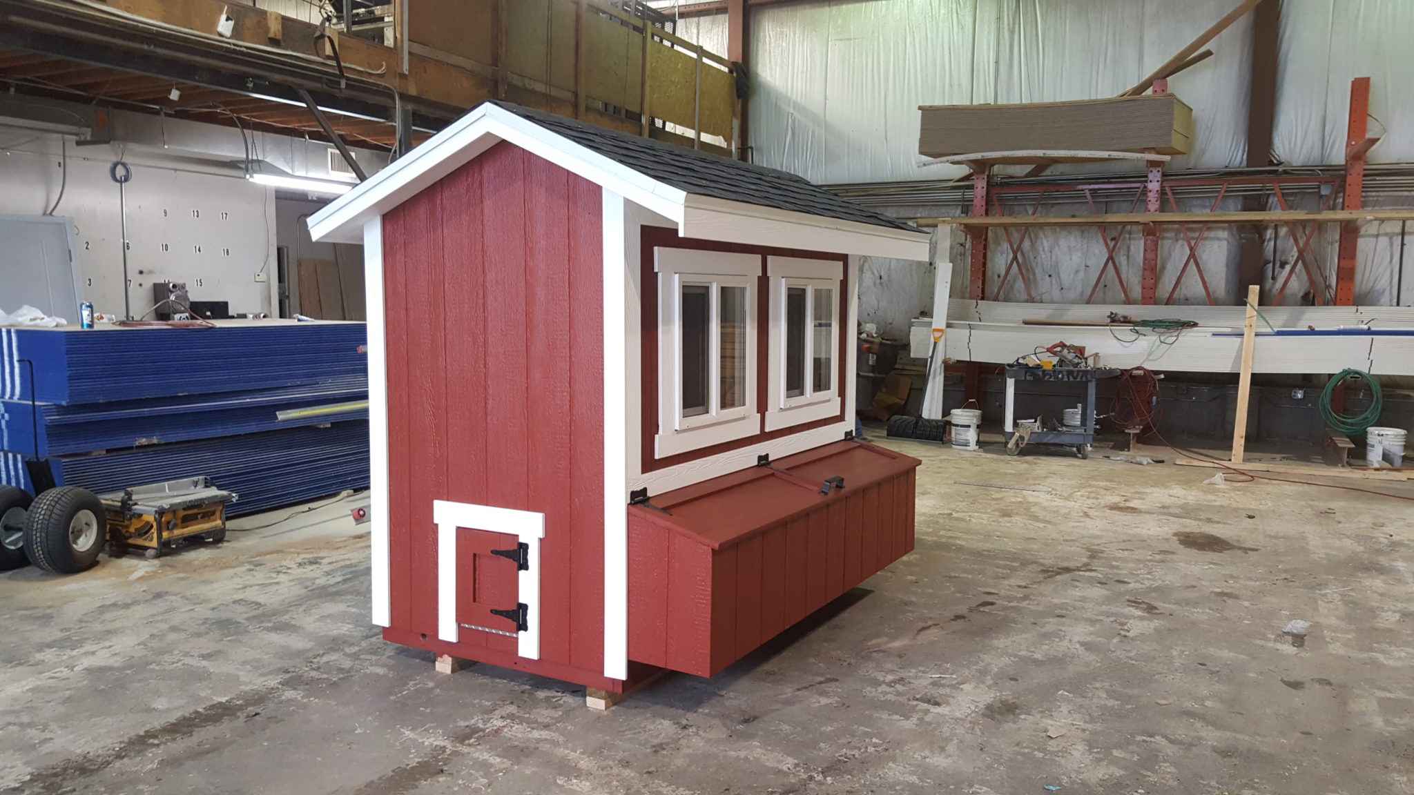 Chicken Coop With Windows and Nesting Boxes for 4 Hens Red wooden chicken coop for 4 hens featuring side windows, built-in nesting boxes, secure access door, and compact shed-style design.