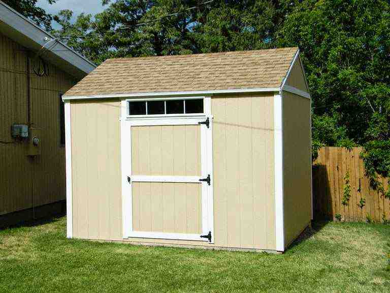 Completed tan backyard shed with white trim built using DIY shed kits Utah—durable and ready for use