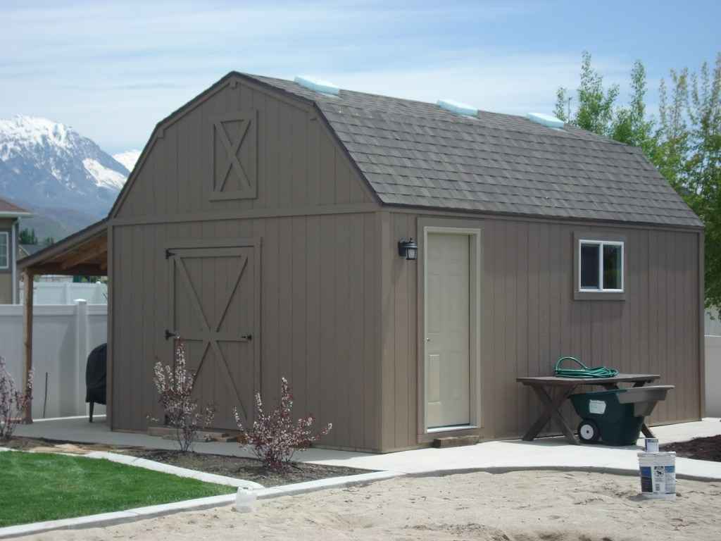 Brown barn-style shed with gambrel roof, man door, and window, ideal for equipment storage sheds in beatrice nebraska