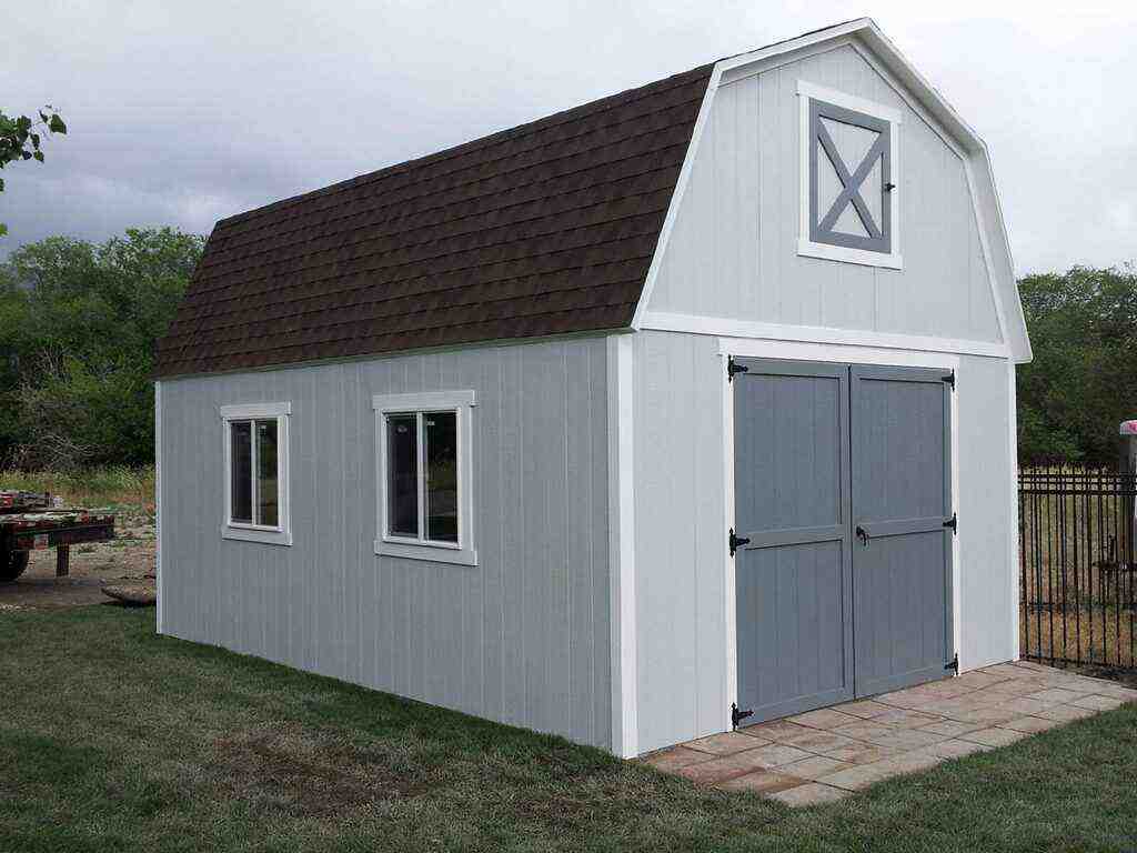Gray barn-style storage shed with gambrel roof and double doors – backyard shed focus.