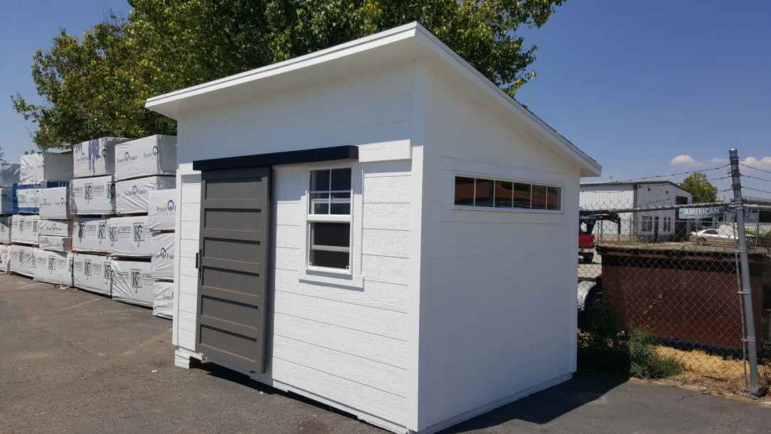 White Modern Lean-To Shed A white lean to shed with a gray sliding door and side window, showcasing a stylish local rent to own sheds design option.