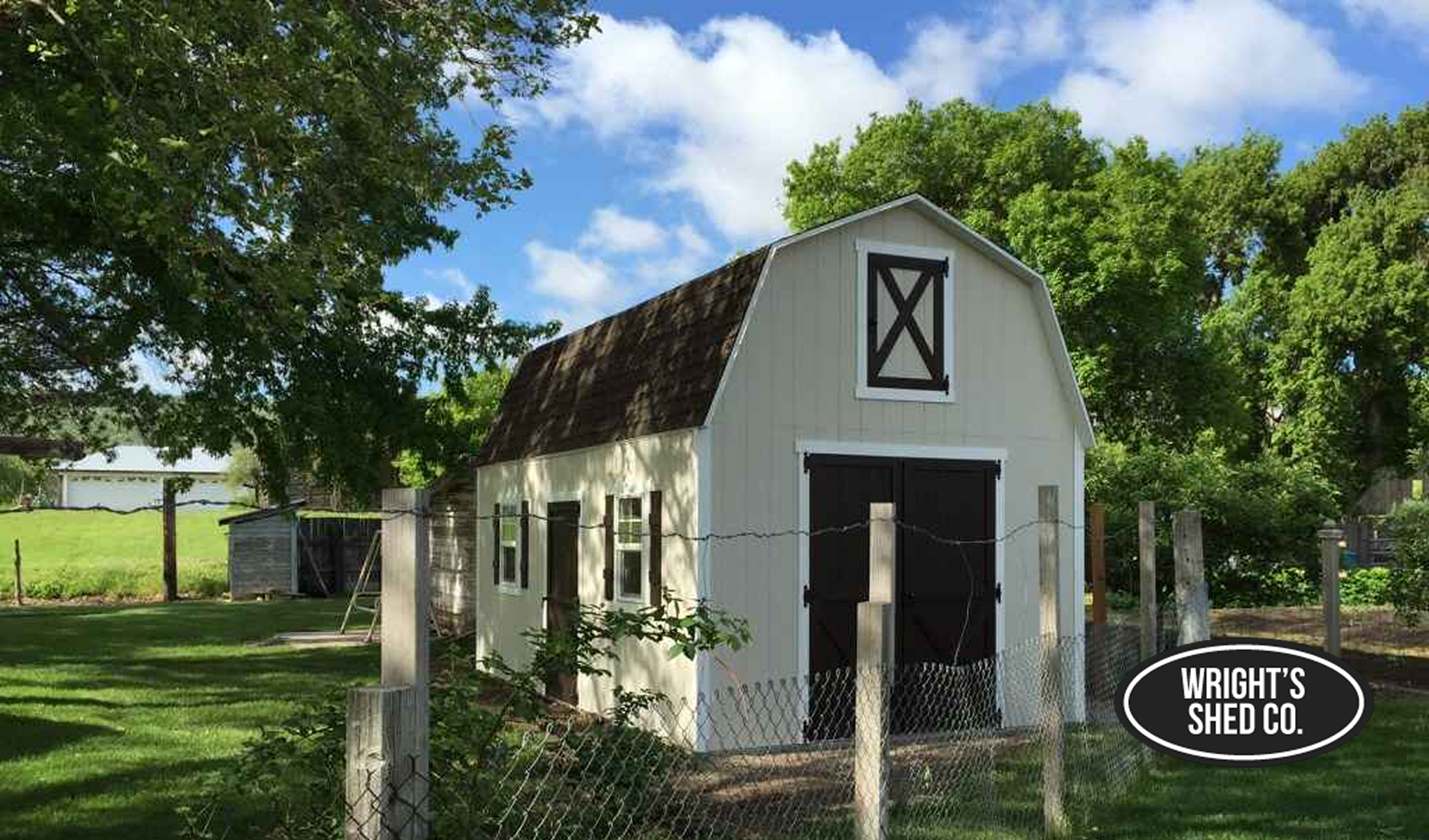 Farm-Style Barn Shed With Lofted Design White farm-style barn shed with gambrel roof and double doors, showcasing classic barn sheds for storage, tools, and rural use.