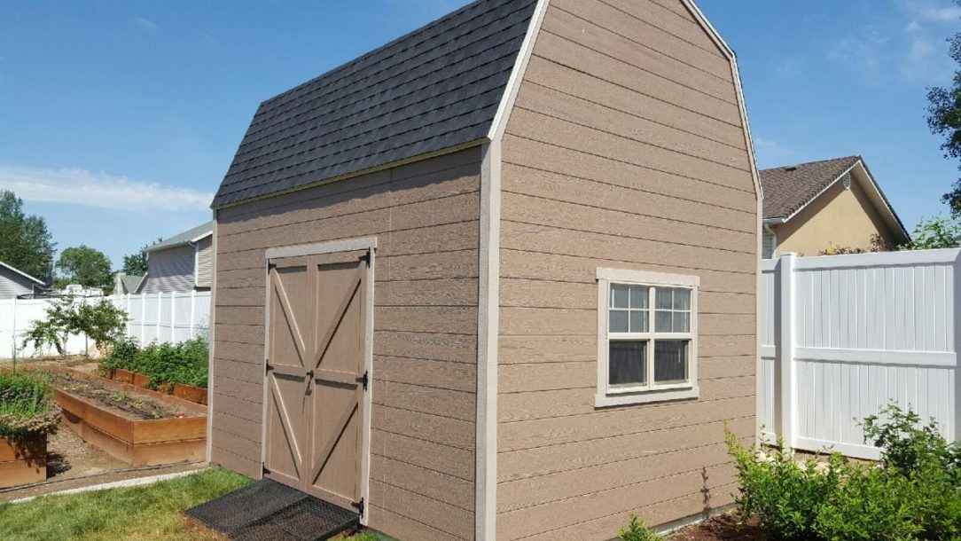 Beige barn-style shed with double doors, side window, and small ramp built by Wright’s Shed Co. for functional backyard storage.
