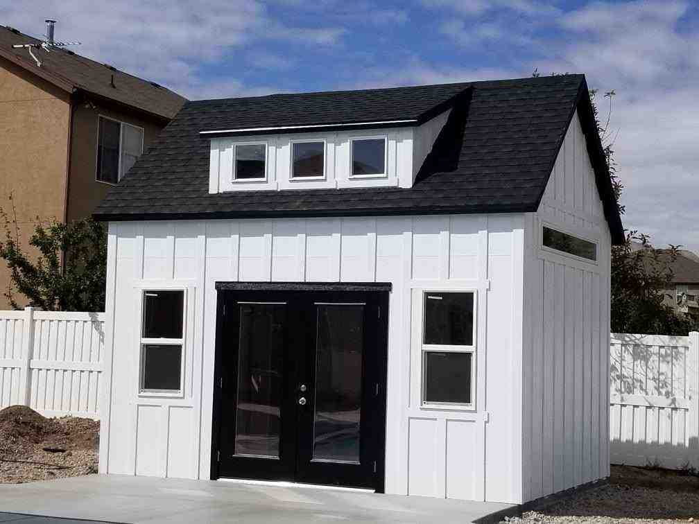 White climate controlled storage shed with black double doors and modern design.