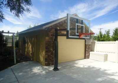 yellow garage with rock