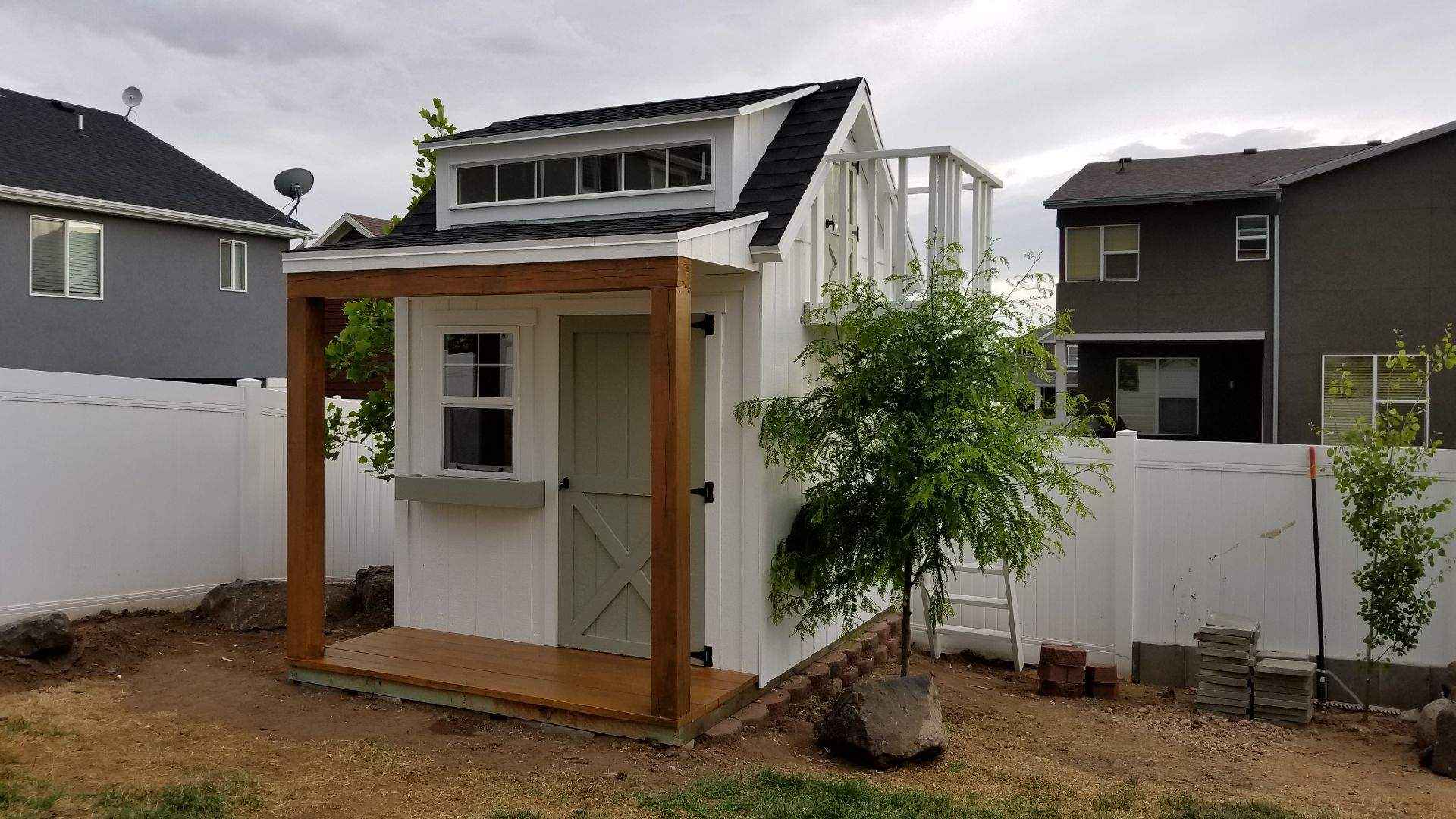 custom-built shed with high ceilings and a storage loft