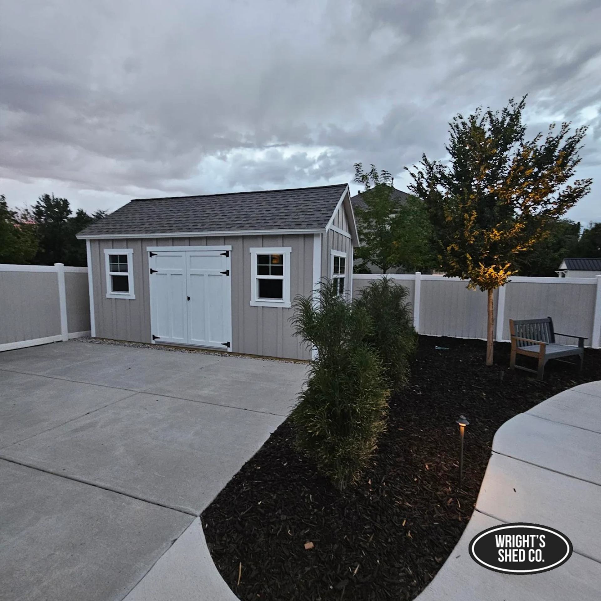 Gray shed with double doors and windows illustrating practical features to maximize shed storage and organization.