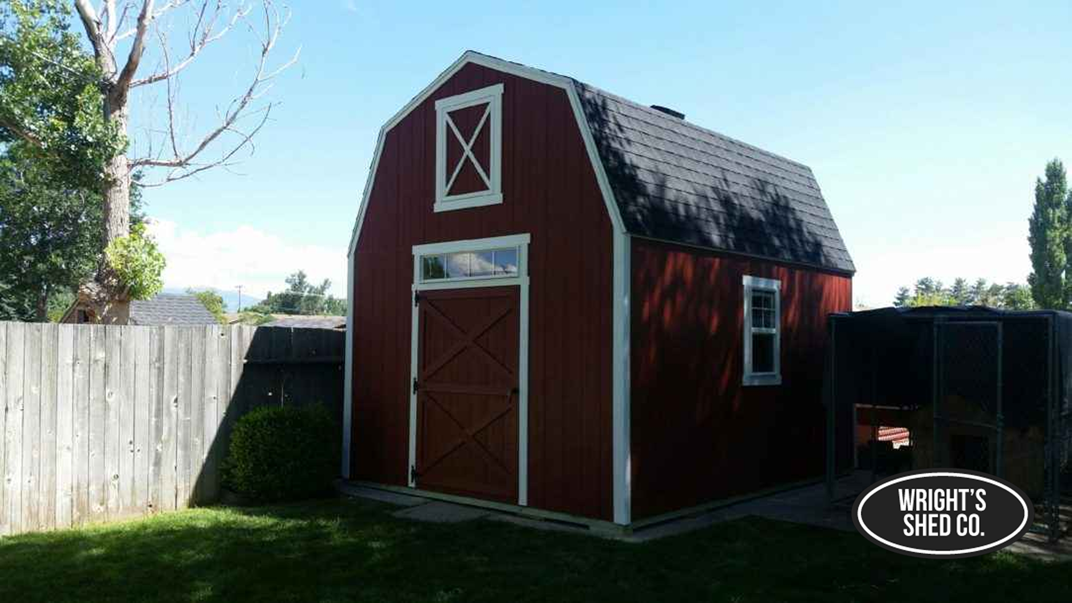 Rustic Barn Shed for Backyard Storage Red gambrel-style barn shed in a fenced yard featuring custom shed ideas with loft storage, white trim, and a classic farmhouse look.