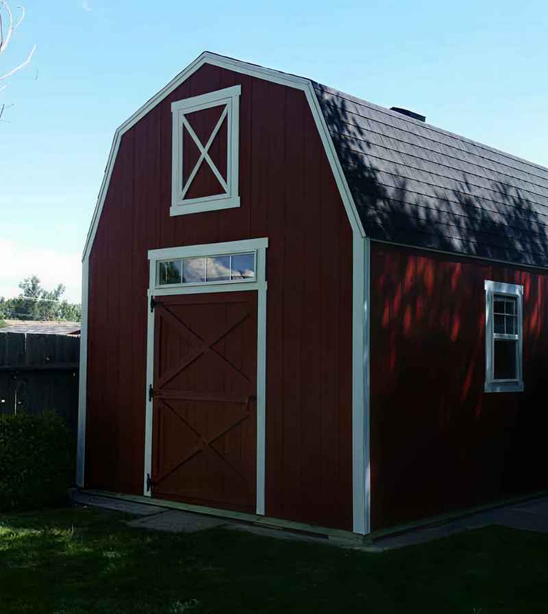  Custom shed materials featured on a double-door farm style shed with engineered siding, asphalt shingles, and window trim.