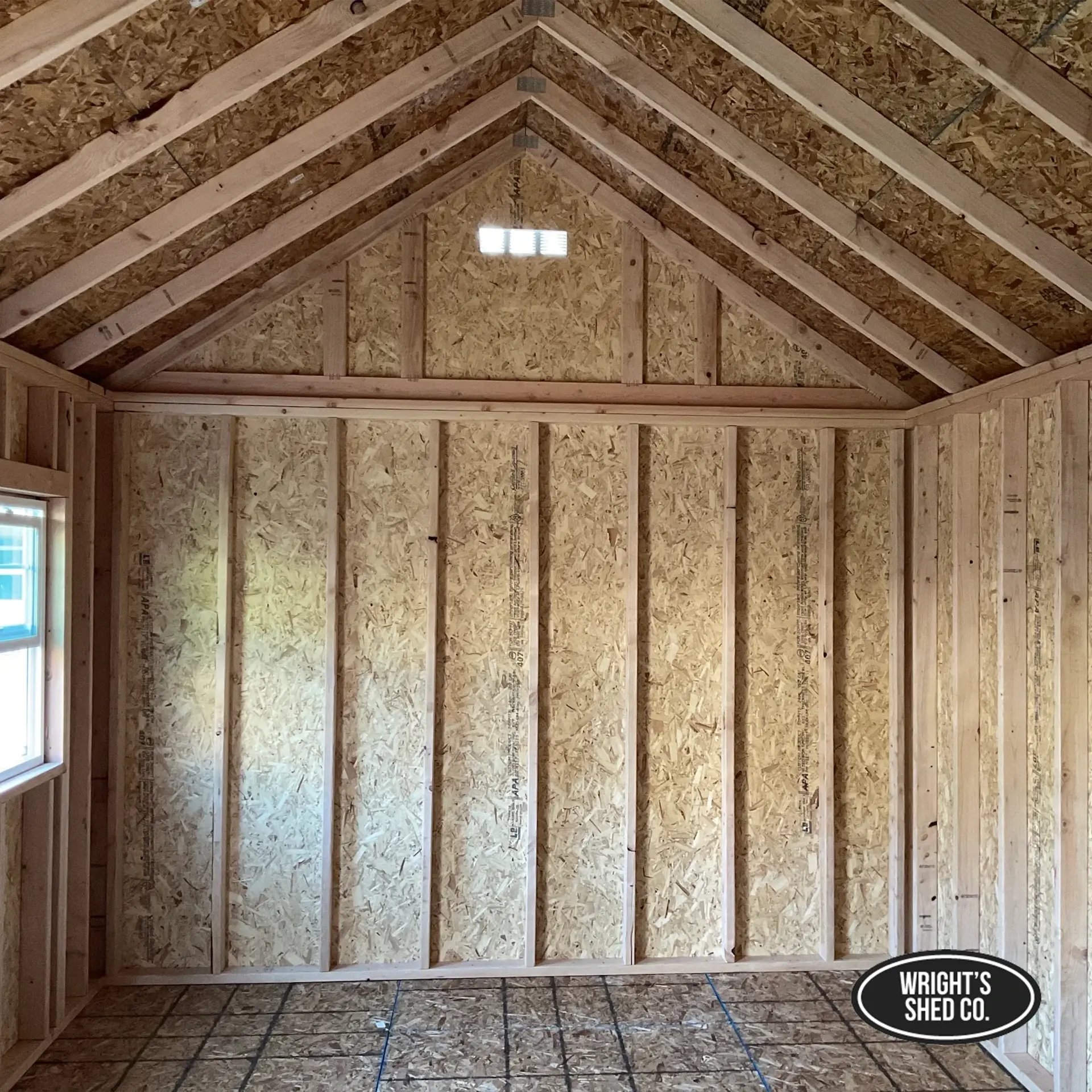 How a custom sauna is built, showing the framed interior walls, roof structure, window, and plywood sheathing.