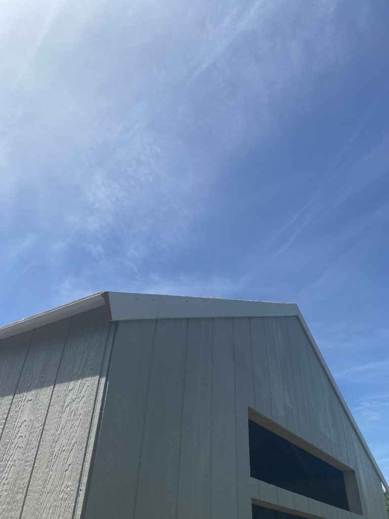 corner of white trim on grey shed