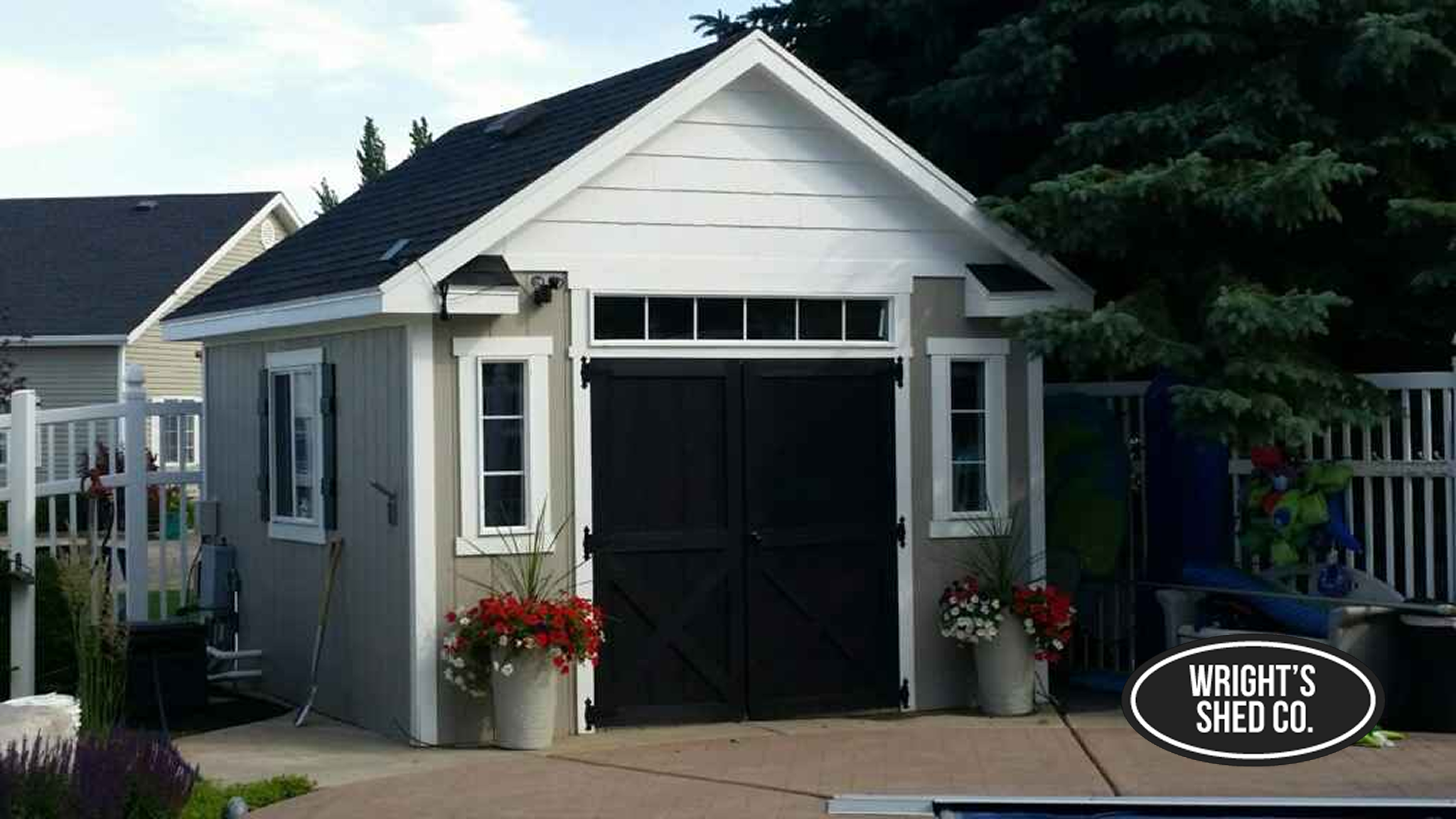 Custom Orchard Shed Design Inspiration Elegant backyard storage building showcasing custom shed ideas with black double doors, transom windows, and modern farmhouse style.