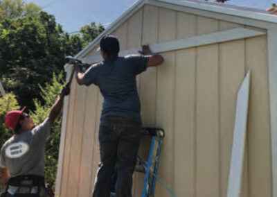 a group of men working on a shed