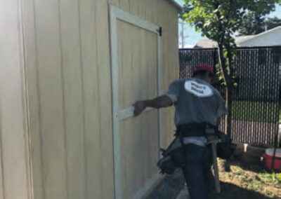 Man holding shed's door