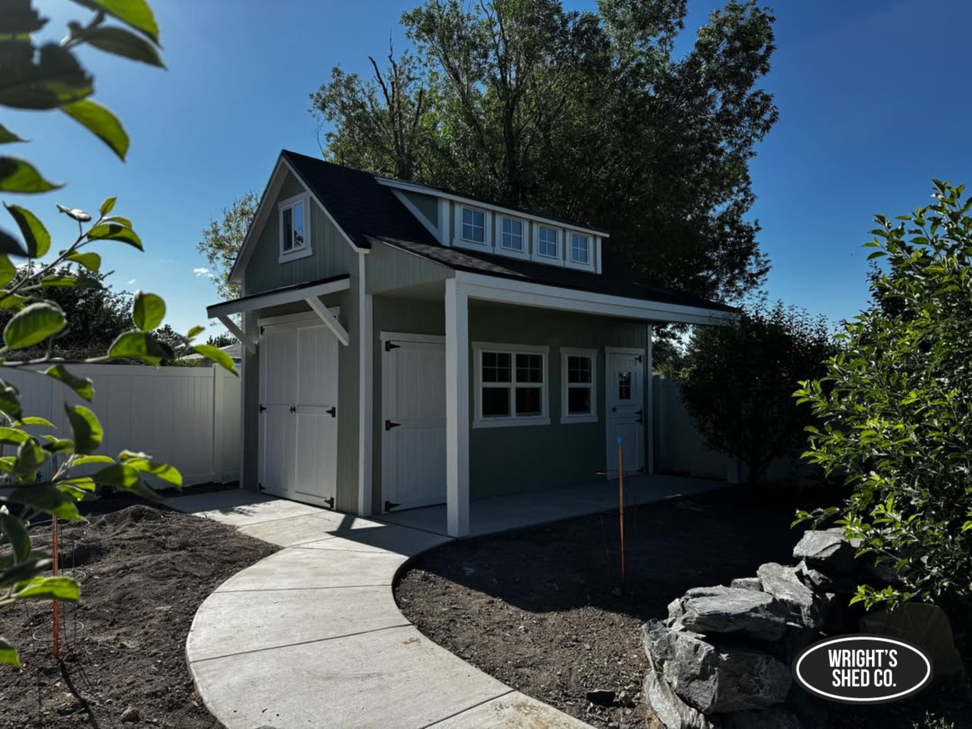 Custom shed planning featuring a modern backyard shed with covered porch, loft windows, and durable custom design.