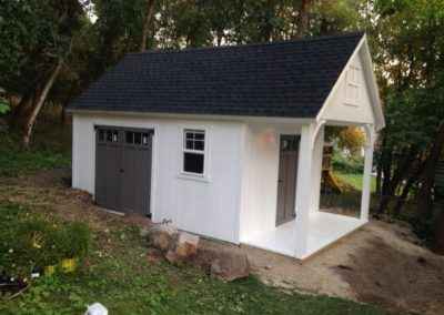 white orchard shed with gable porch